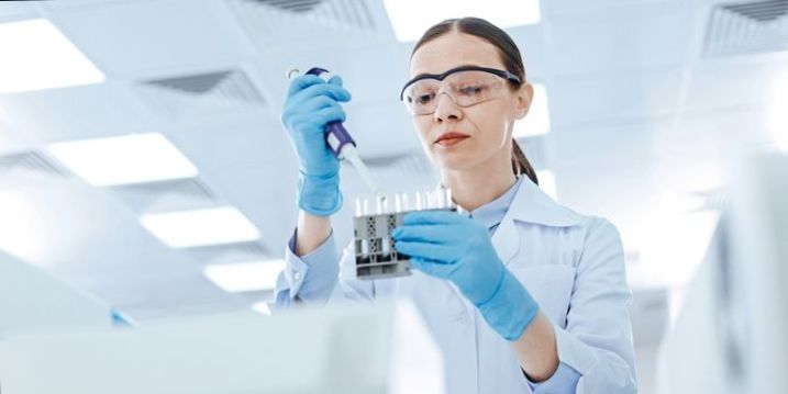 A genomics technician in a lab.