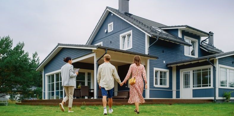 A real estate agent showing a home to a couple.