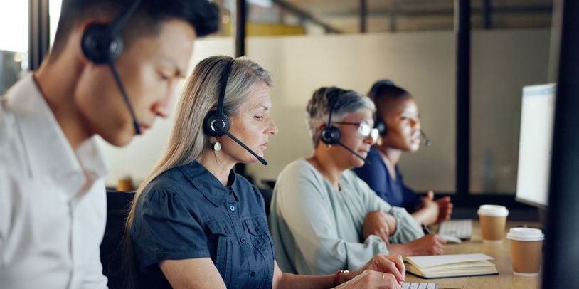 Several telemarketers working at a call centre.