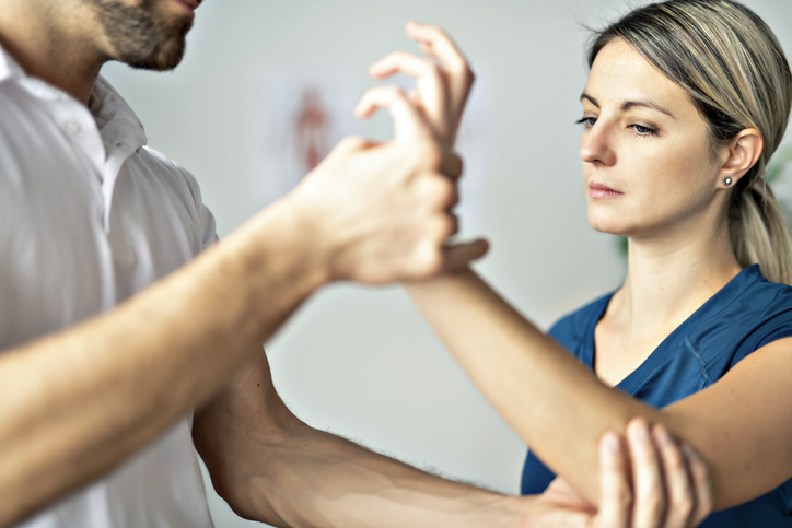 A hand therapist working with a client.
