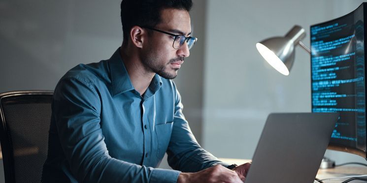 A search engine optimization (SEO) specialist working on his computer.