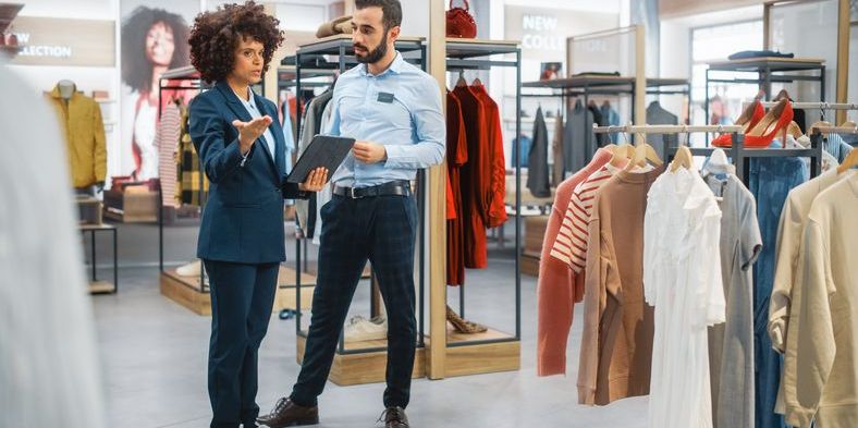 A retail manager talking to the store manager of a retail store.