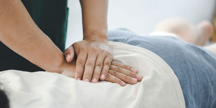 A chiropractor adjusting a patient.