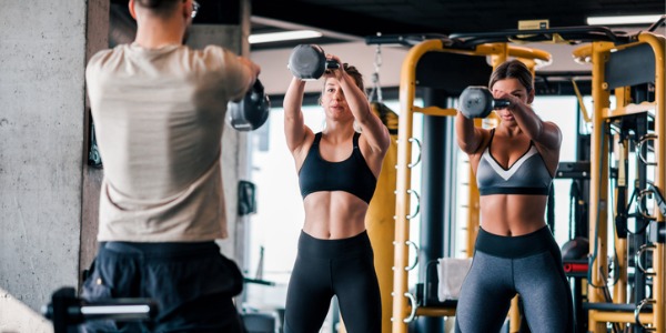 A fitness trainer holding a strength training class.
