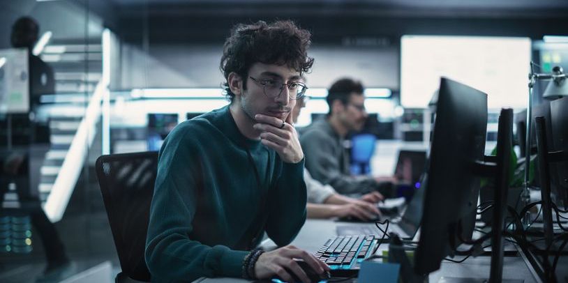 An AI research scientist working on his computer.