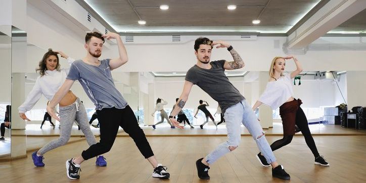 A musical theatre choreographer teaching a dance to performers.