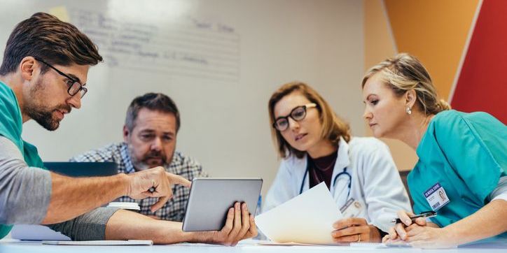 A health policy analyst having a meeting with healthcare providers regarding policy strategies.