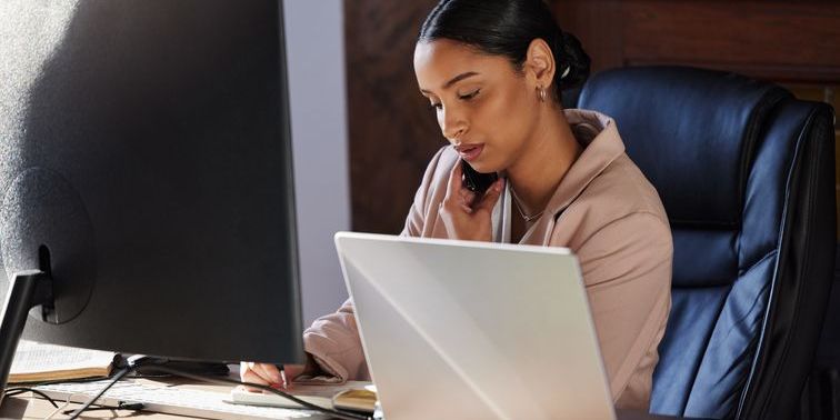A regulatory compliance officer working at her desk.