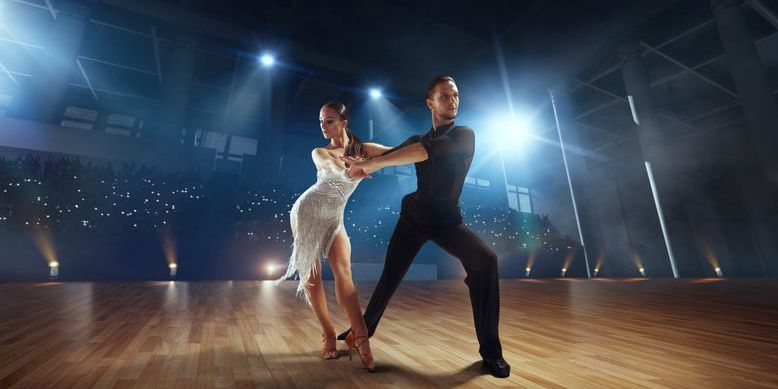 A ballroom dance couple performing at a dance competition.
