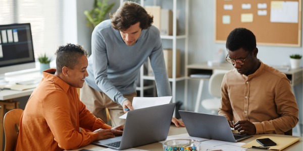 A site reliability engineer collaborating with software developers.