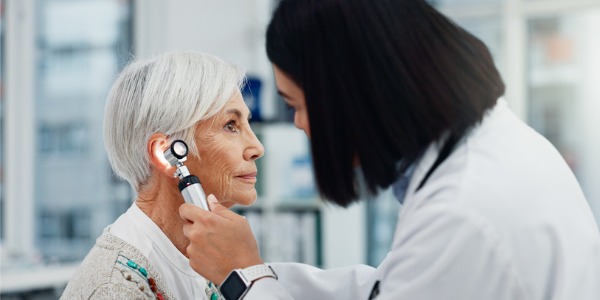 An otolaryngologist looking in a patient's ear.