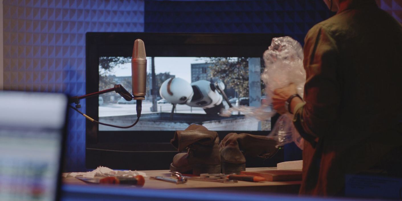 A Foley artist rustling some plastic to make a sound effect.