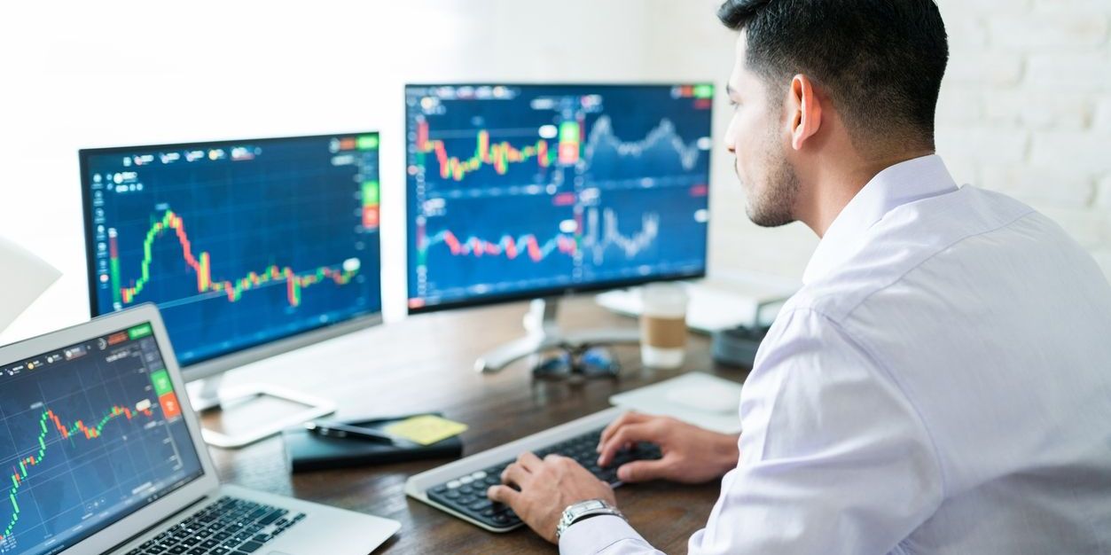 A day trader working on his computer.