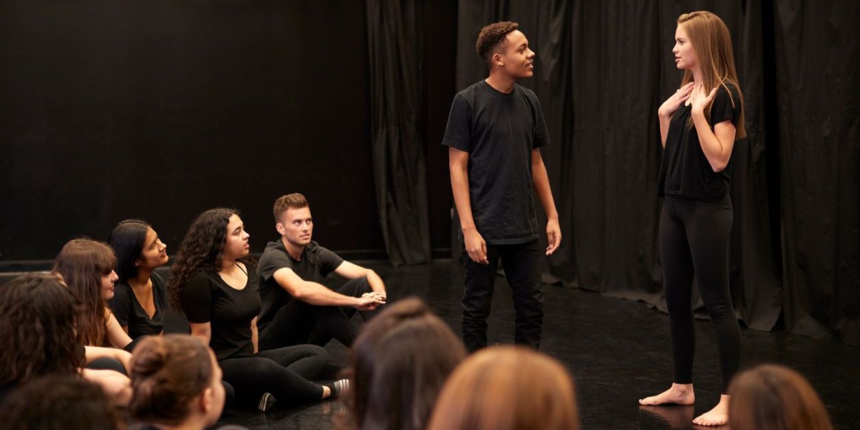 Two improv actors on stage.