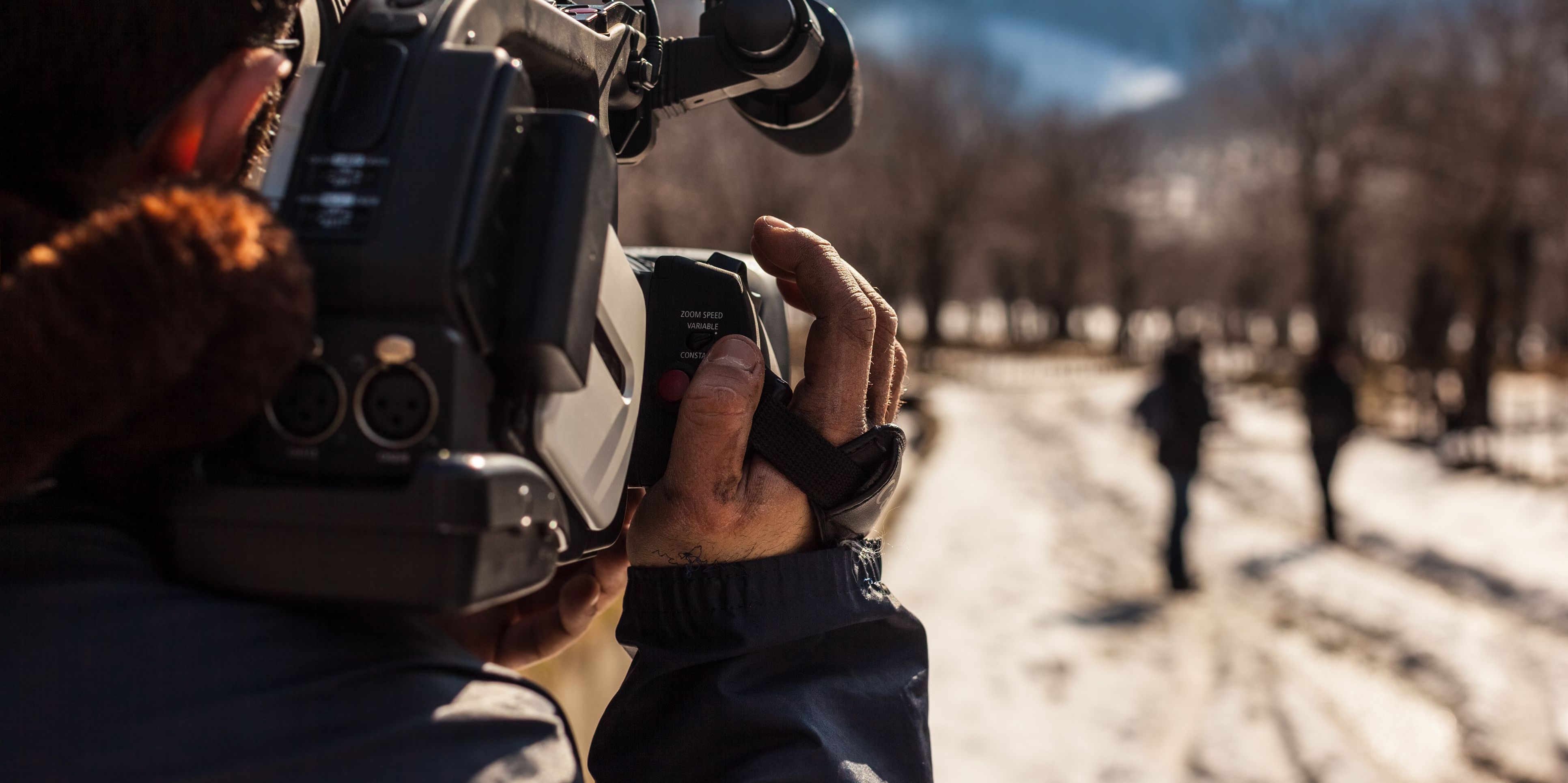 A documentary filmmaker capturing footage.