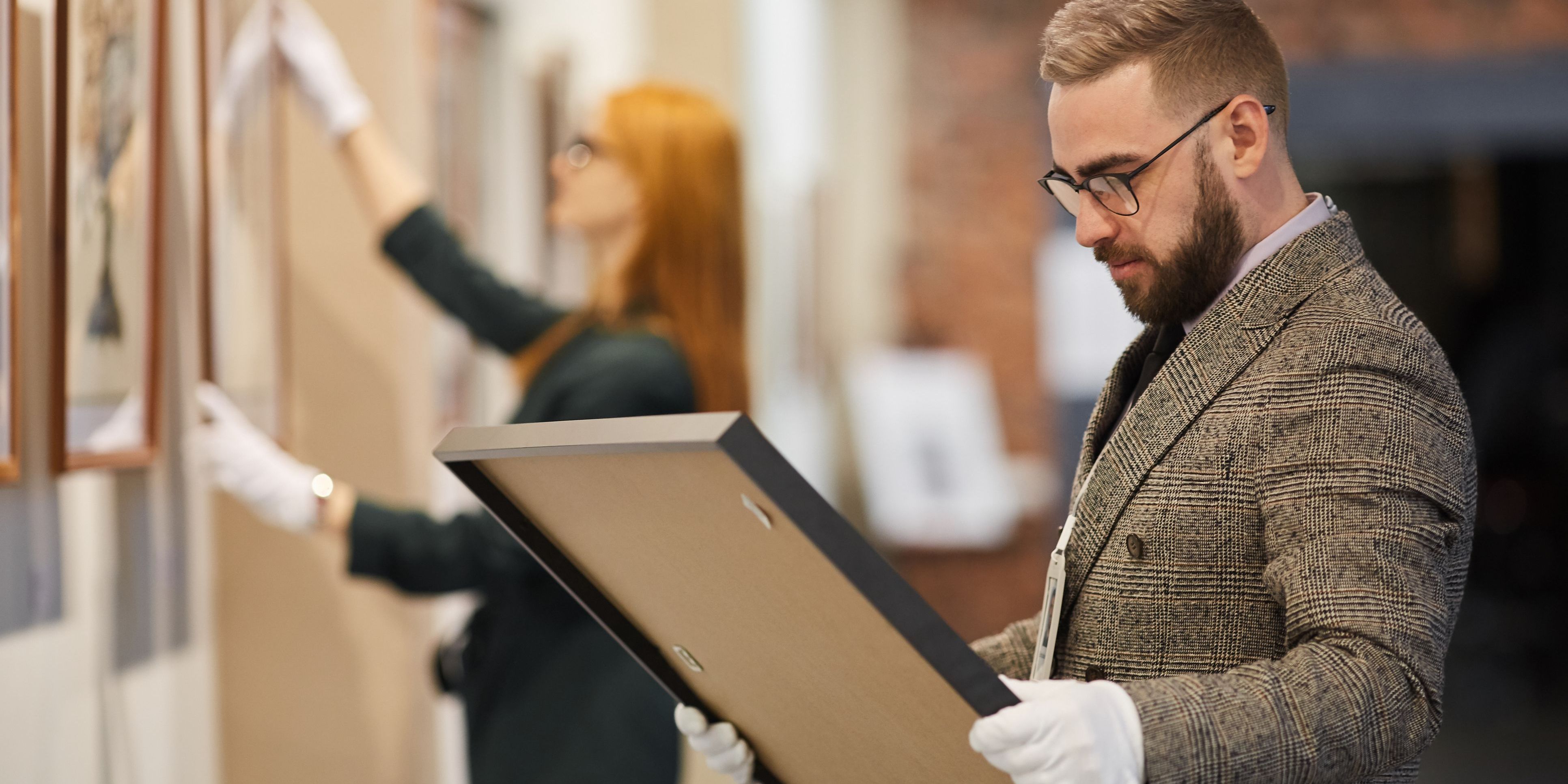 An art appraiser looking at artwork.
