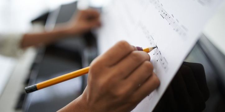 A film composer writing music.