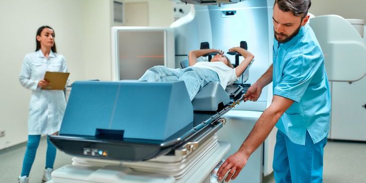 A dosimetrist getting a patient ready for a radiation treatment.