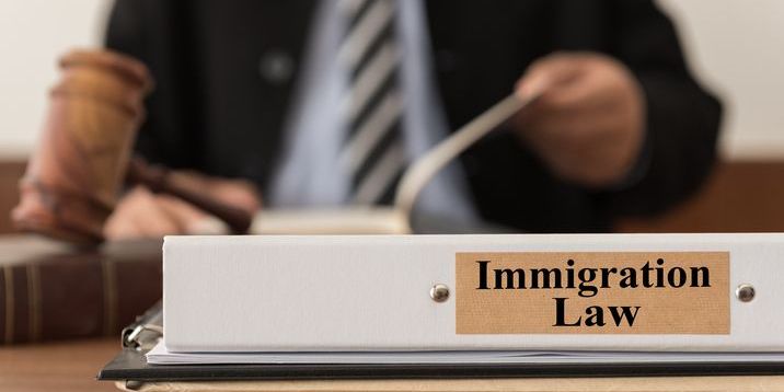 An immigration lawyer sitting at his desk.
