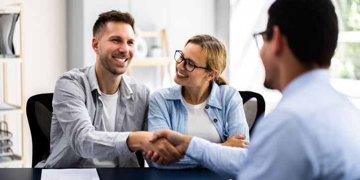 A real estate lawyer going over paperwork with her clients.