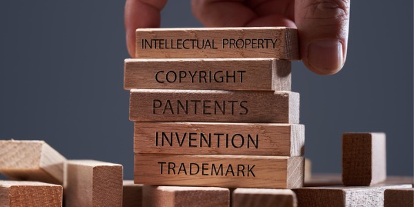 A set of thin wooden blocks naming various aspects of what an intellectual property lawyer would deal with.