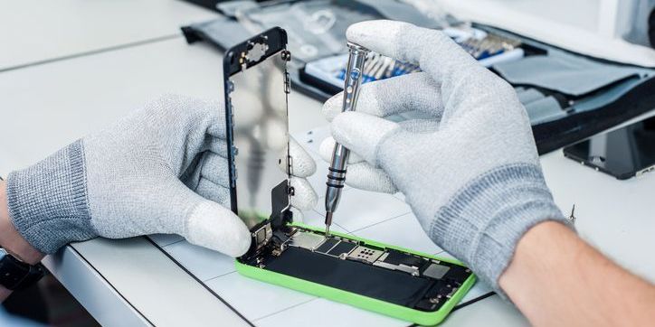 Close-up photos showing process of mobile phone repair made by a mobile device technician.