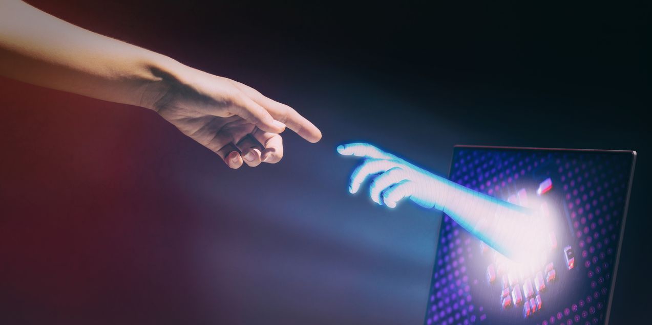 Finger of artificial intelligence through a computer screen and a human are touching. Human-computer interaction technology concept.
