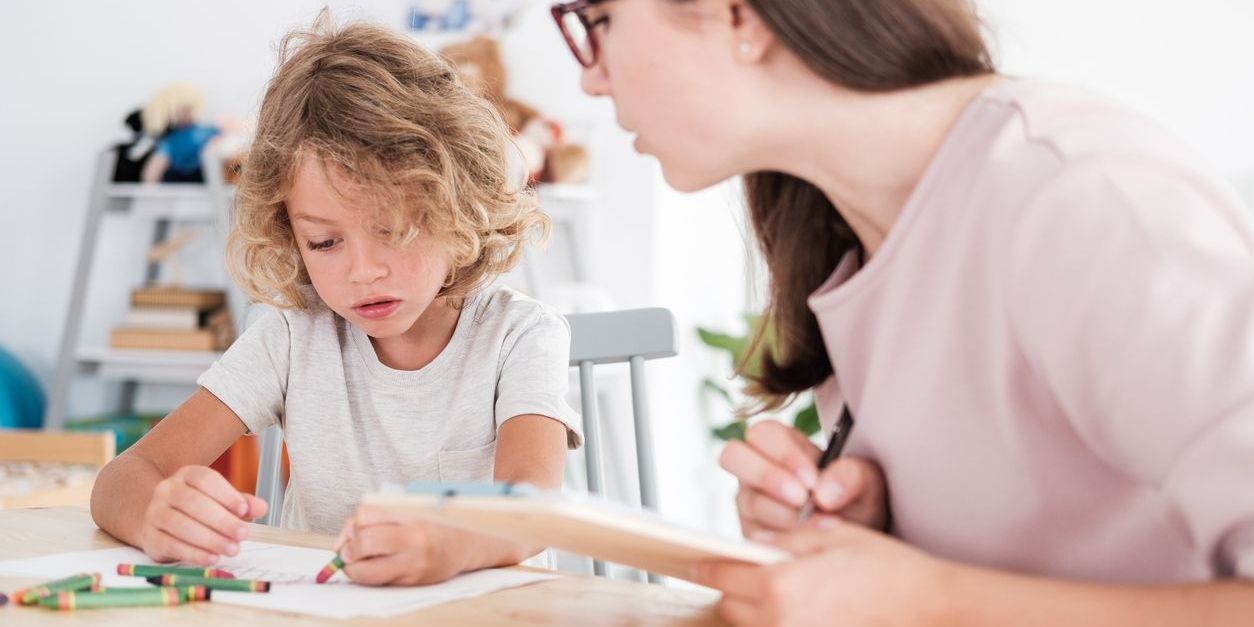 An autism teacher working with a student.
