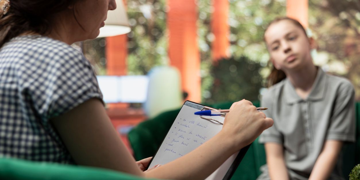 A behavioral therapist evaluating a young girl's behavior and thoughts.