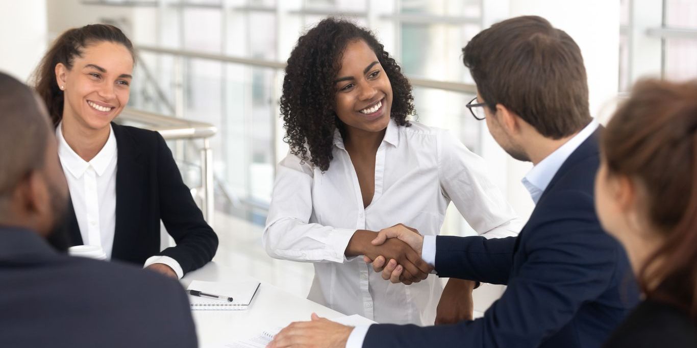 A labor relations specialist shaking hands with an employee.