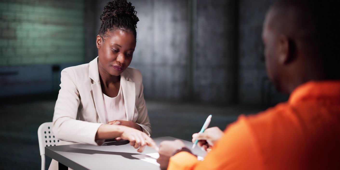 A forensic social worker conducting an assessment with an offender.
