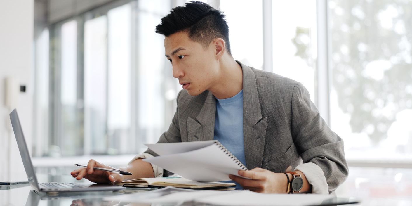 A crime analyst working at his desk, analyzing information.