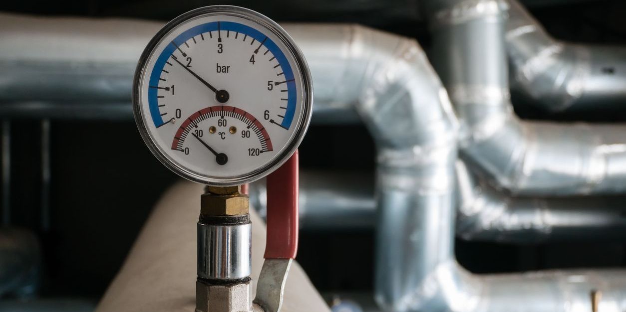 Thermomanometer with brass fitting and stop valves. Device for measuring pressure and temperature in the heating system, installed by steamfitters.