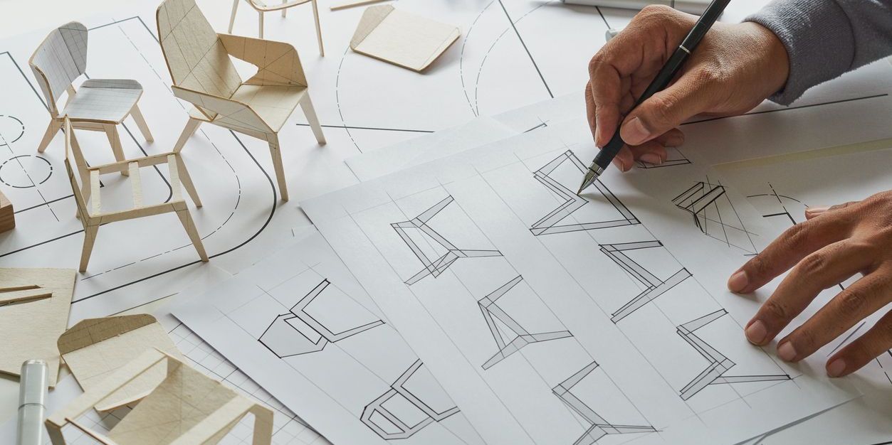 A furniture designer creating a detailed sketch of a chair.