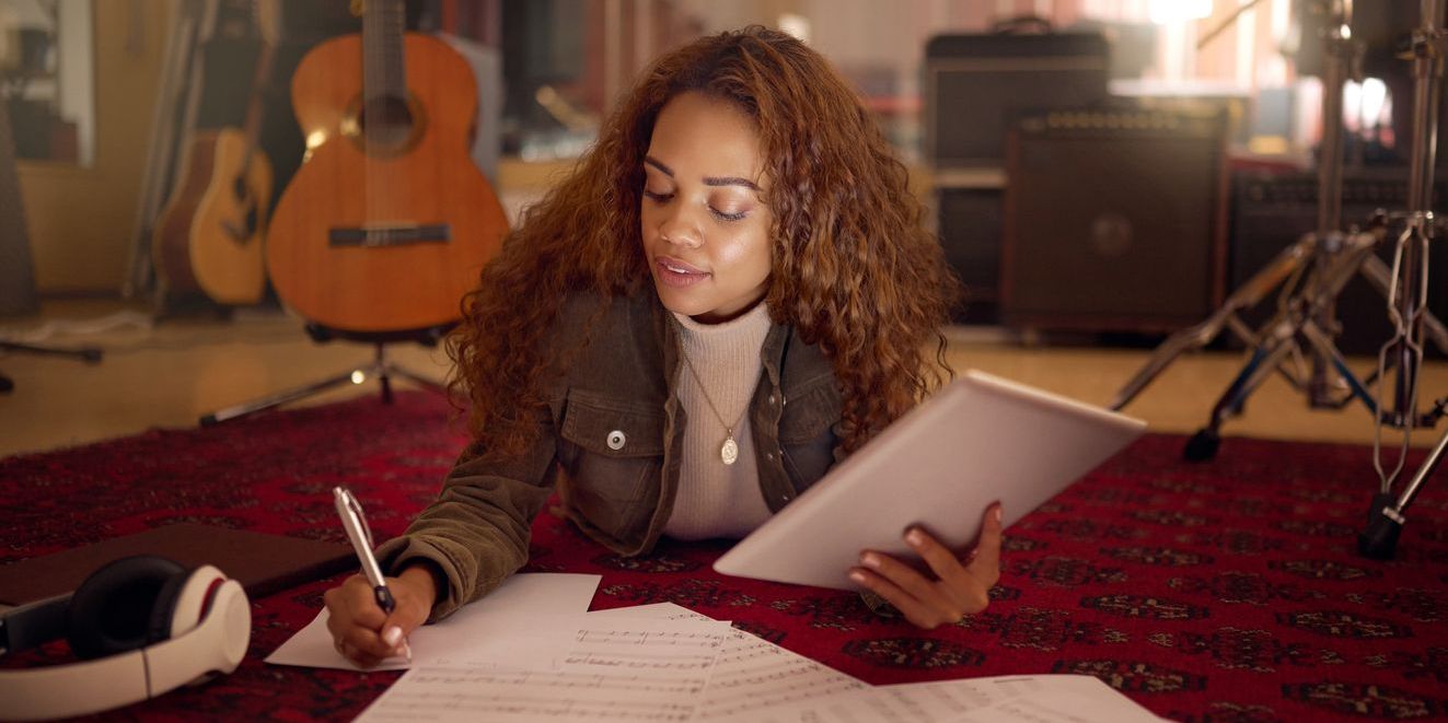 A songwriter writing lyrics for her song.