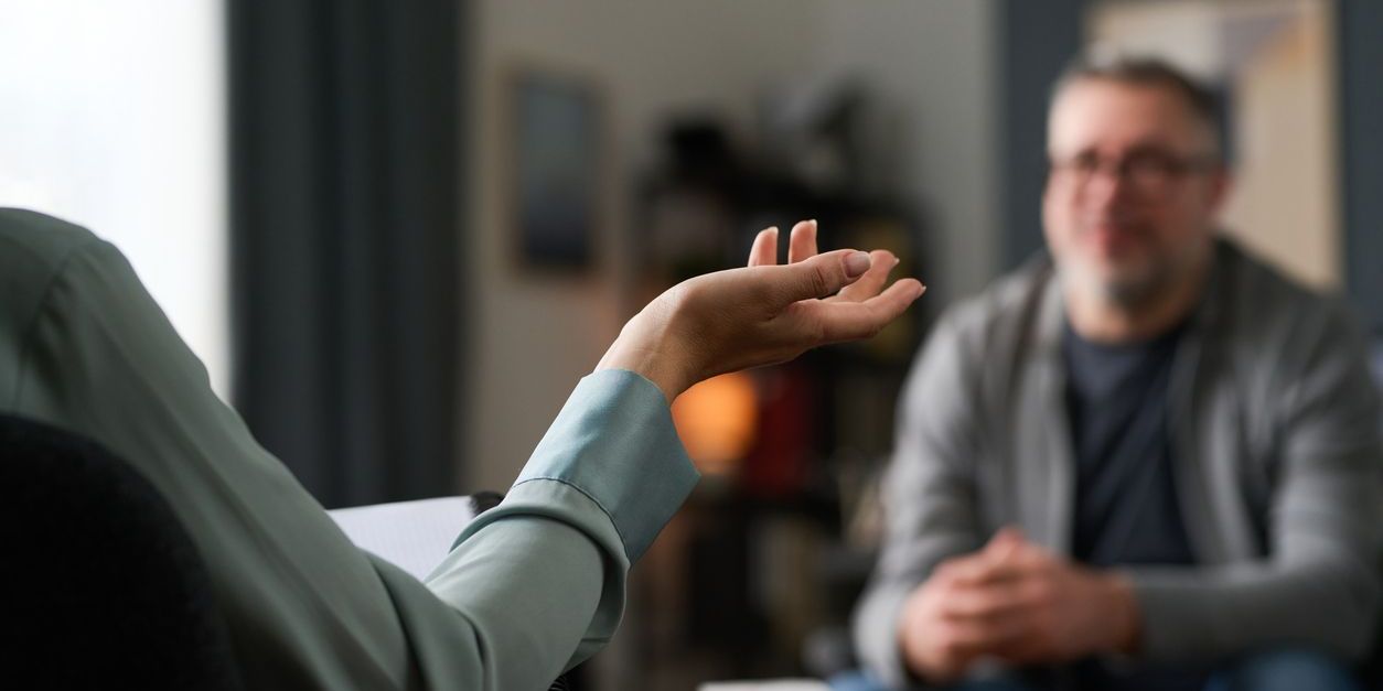 A behavioral health counselor providing support to a male client.