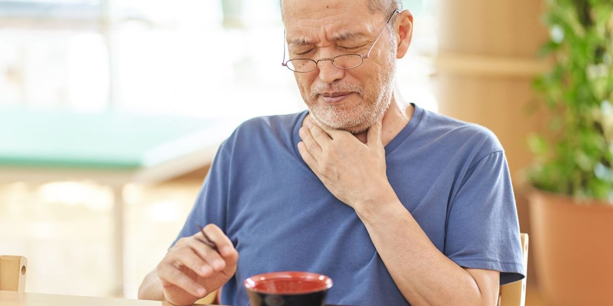 A man having trouble swallowing.
