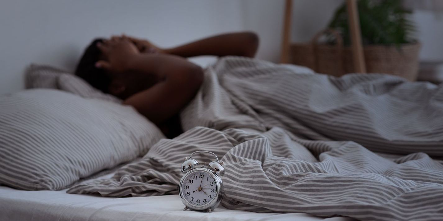 A woman with a sleeping disorder, having trouble sleeping.