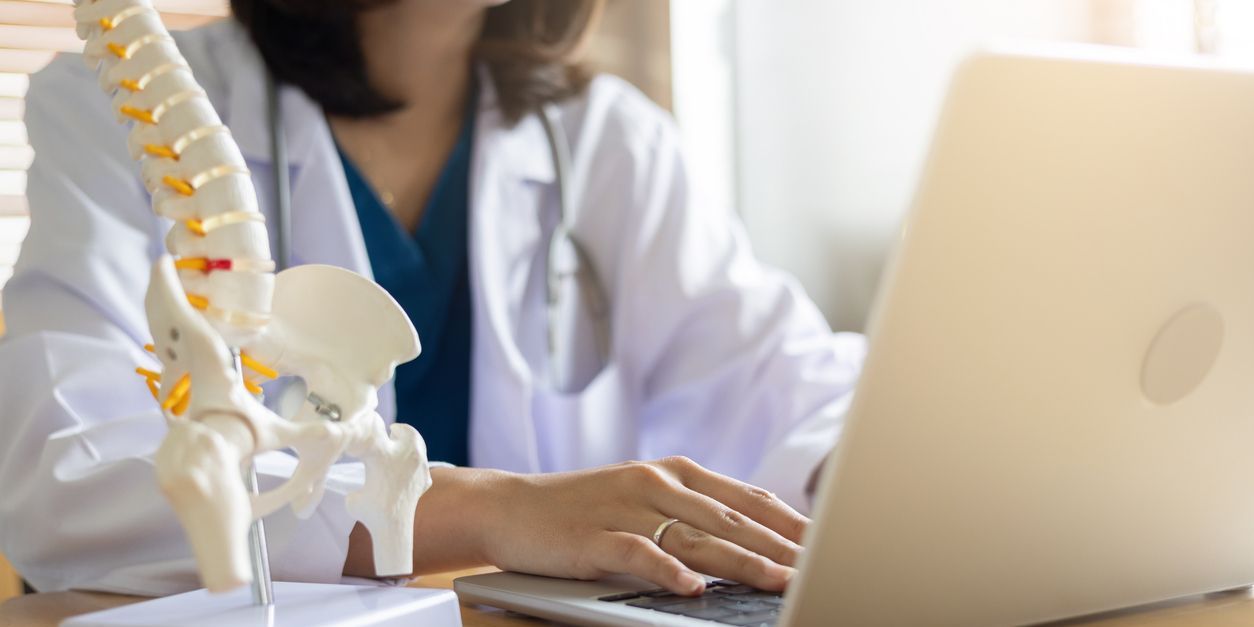 An osteopathic physician working on her computer.