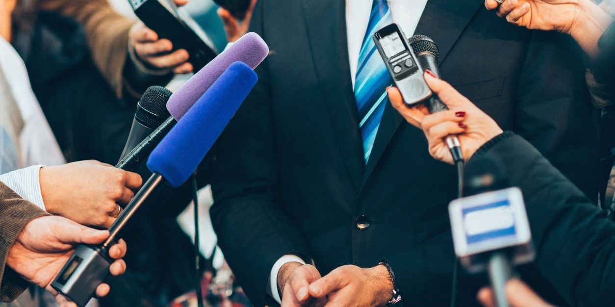 Political journalists trying to interview a politician.