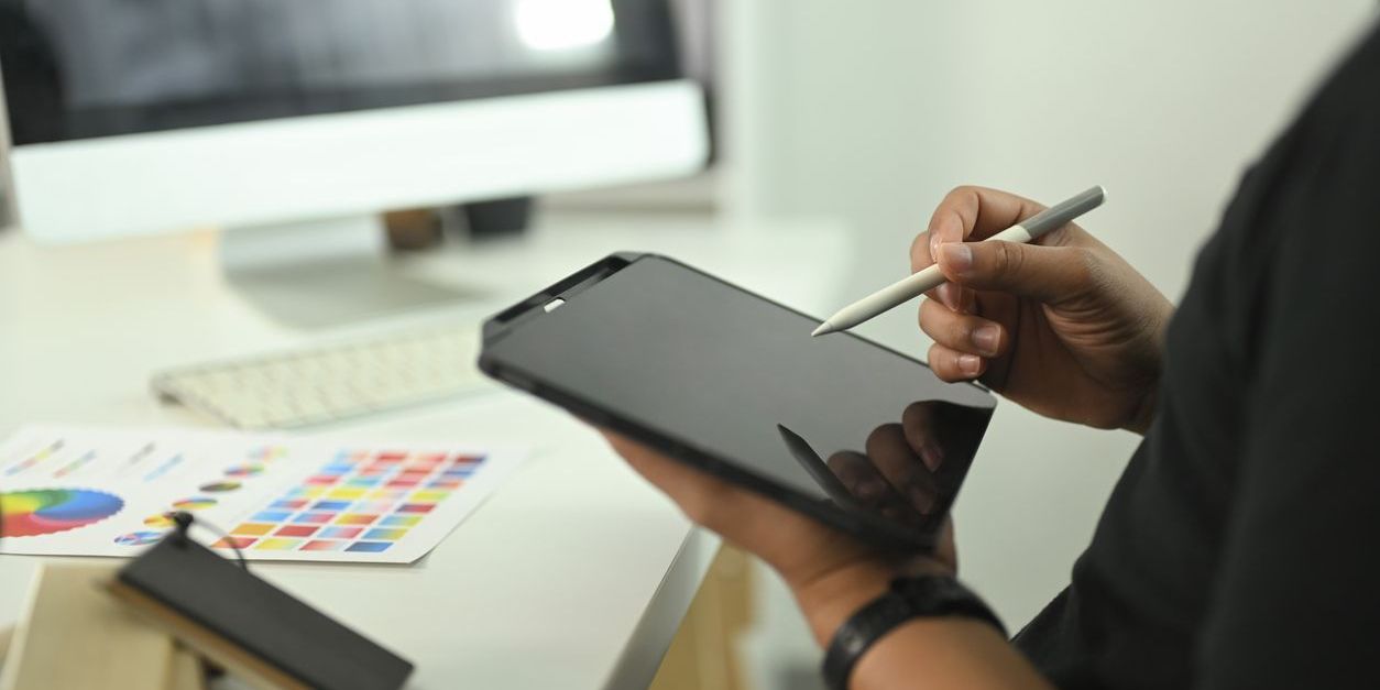 A digital product creator working on a tablet.
