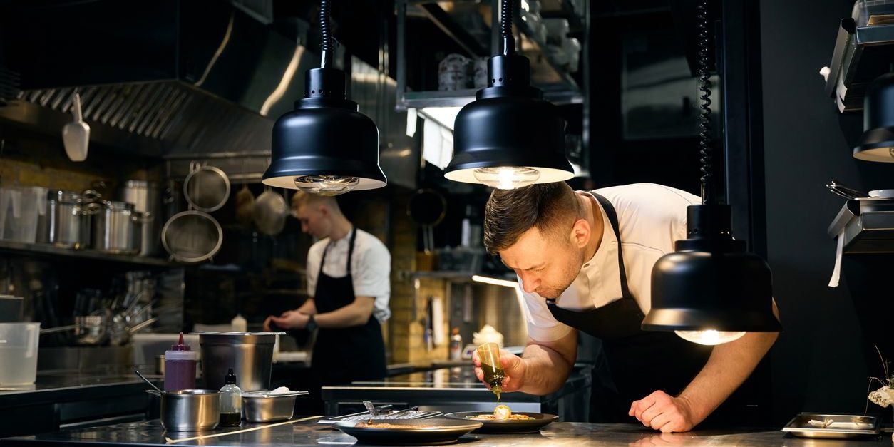 A line cook working in a restaurant kitchen.
