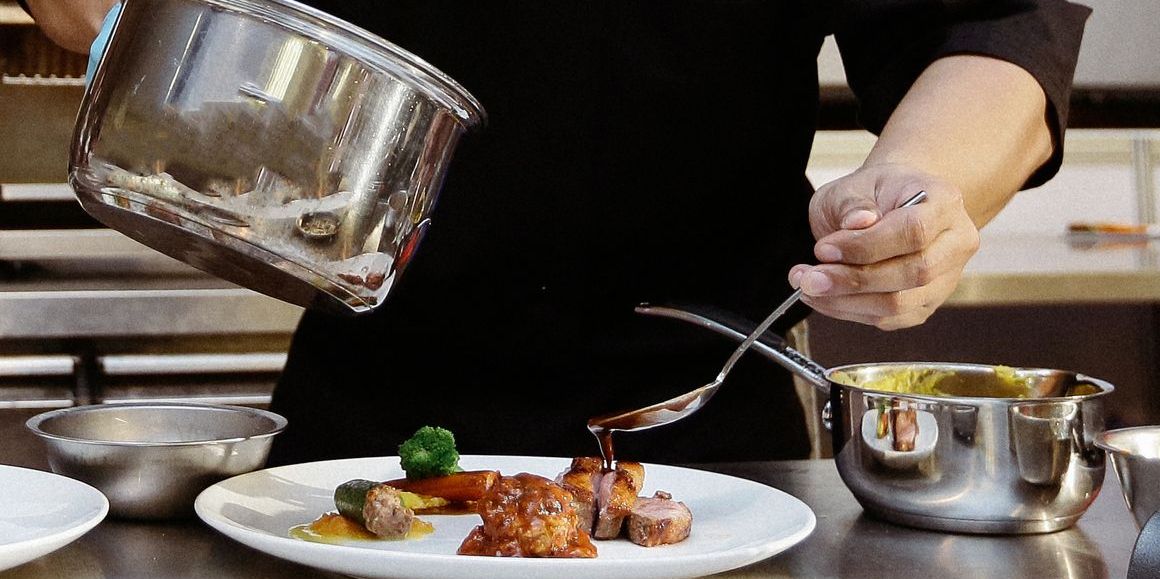 A saucier working in a restaurant kitchen.