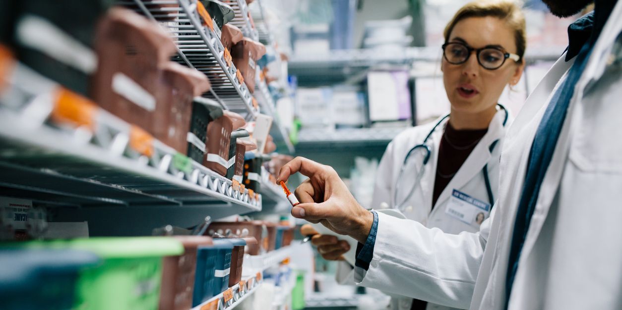 A hospital pharmacist checking inventory at a hospital pharmacy.