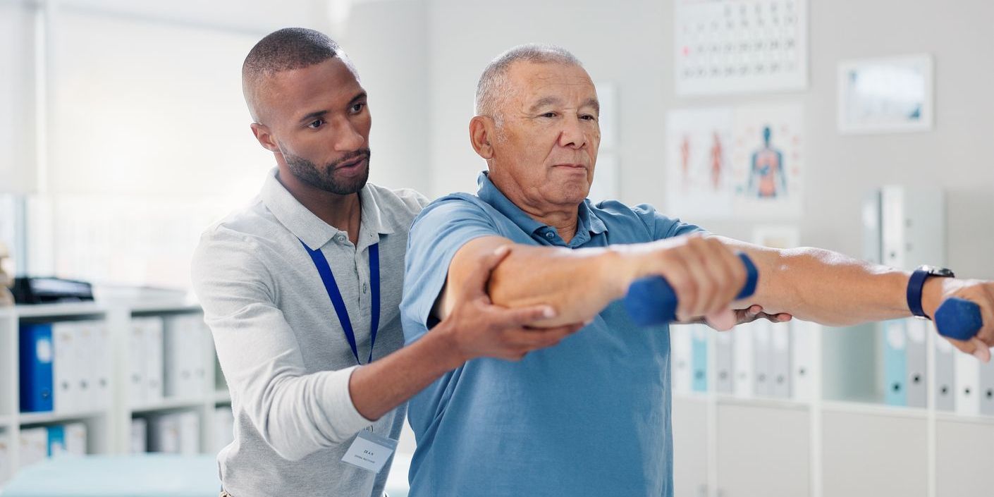 A geriatric physiotherapist helping a patient with exercises.