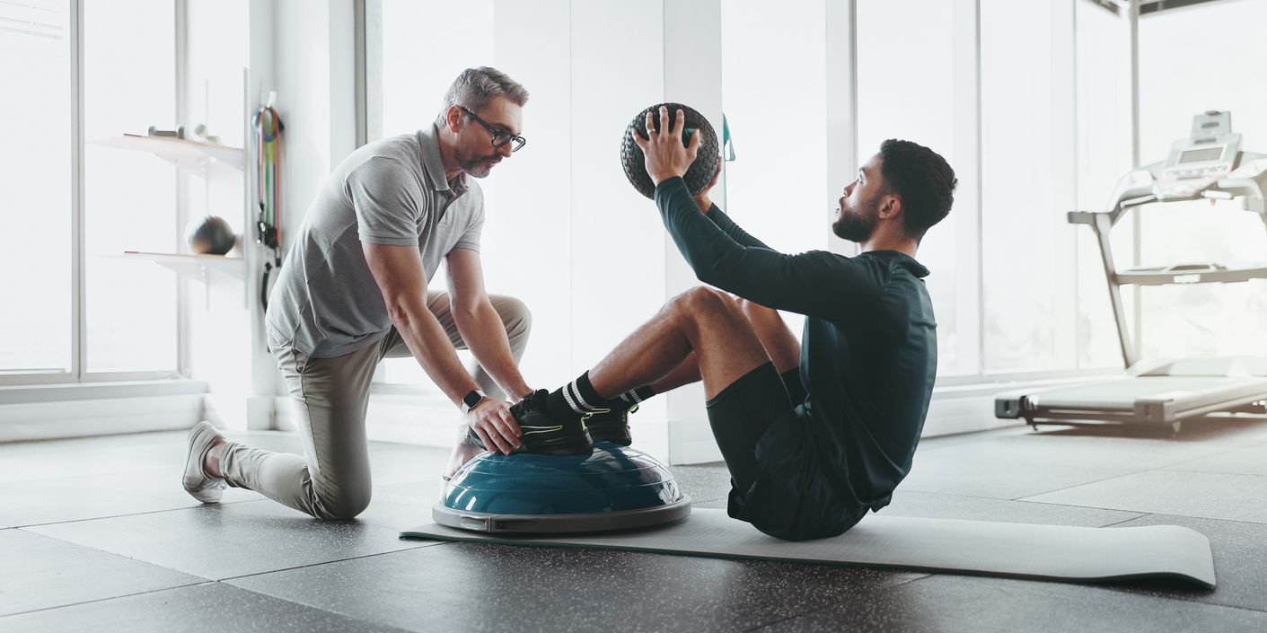 A sports physiotherapist providing treatment for an injured athlete.