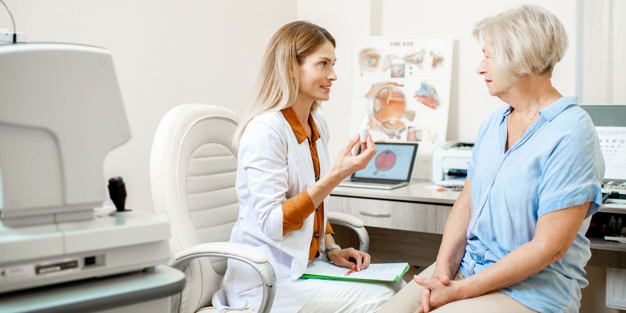 A geriatric optometrist talking to a patient about eye care.