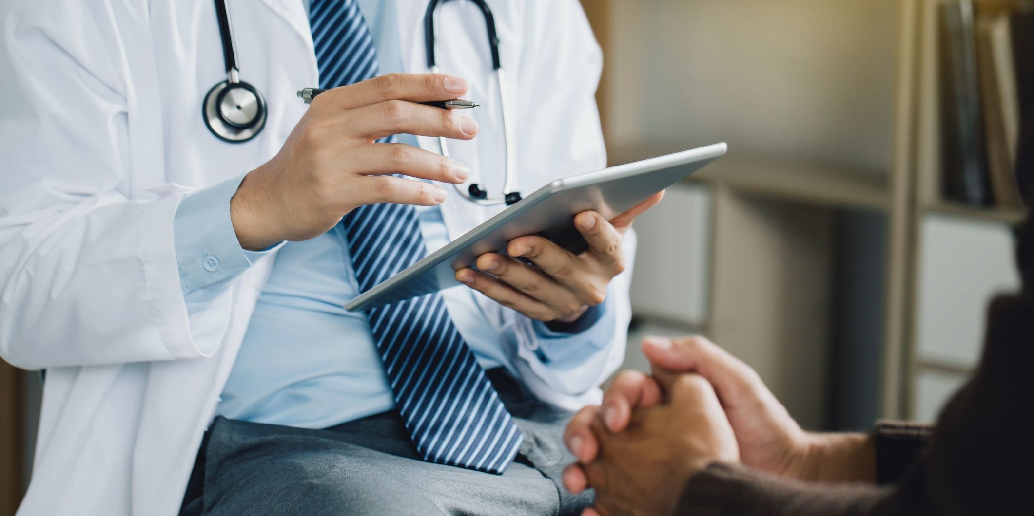 A medical hypnotherapist talking to a patient.