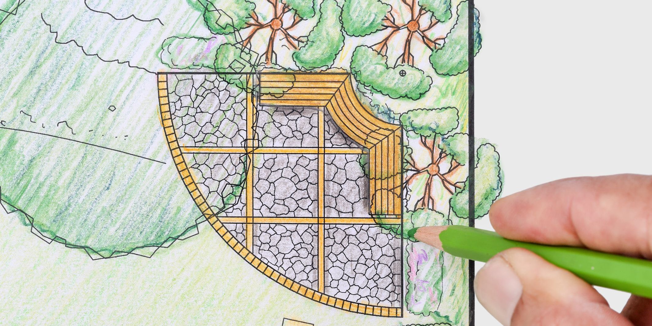 A landscape designer sketching out a garden layout for a client.