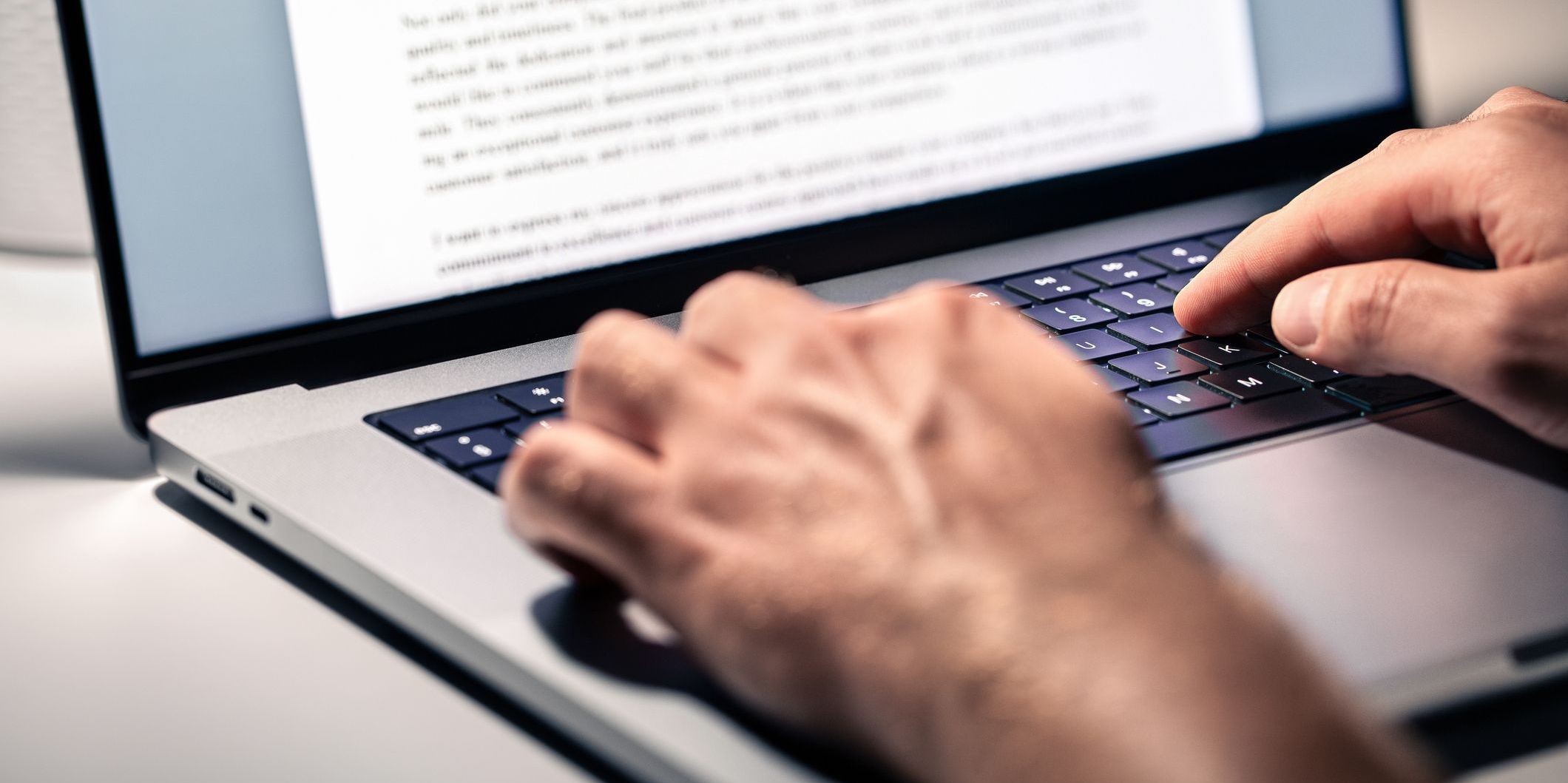 A content editor at his computer, reviewing and editing digital content.